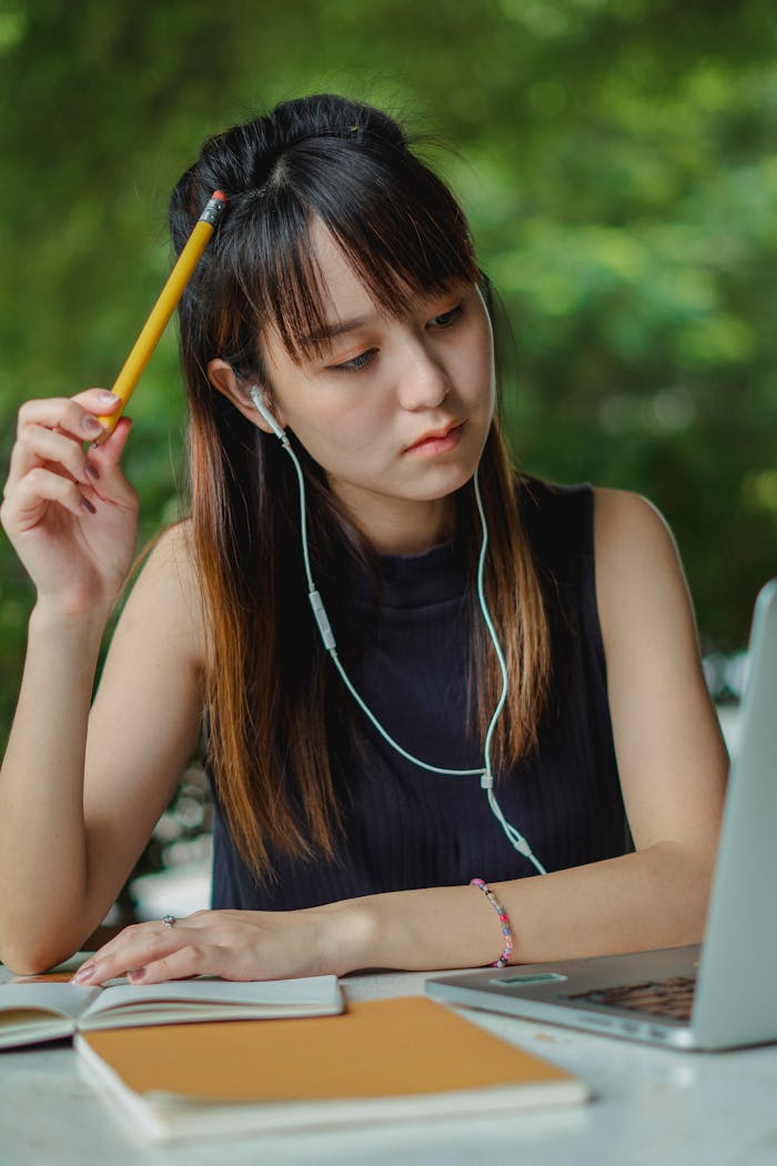 Focused ethnic student watching video lecture